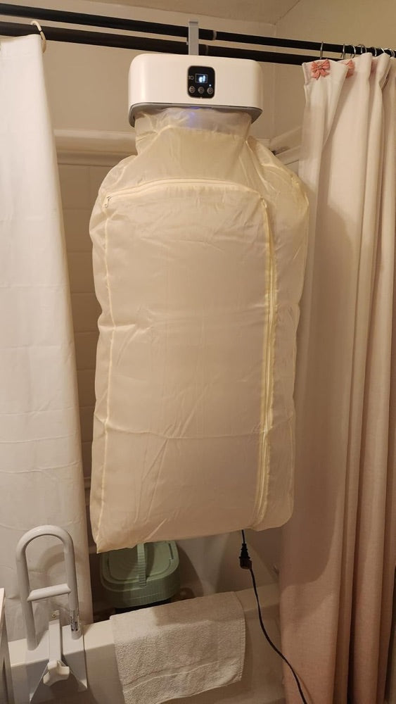 Customer photo: the dryer hung from a shower rail with the cover full of laundry
